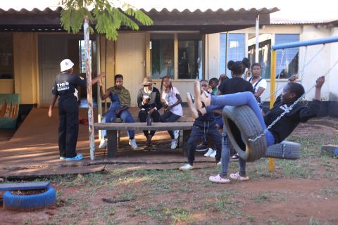 Adolescents and peer educators outside a hospital in Zimbabwe